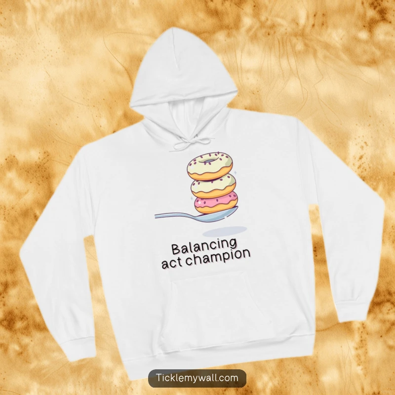 Funny hoodie showing a precarious stack of donuts in a comical balancing act with a spoon, ideal for cozy, humorous wear.