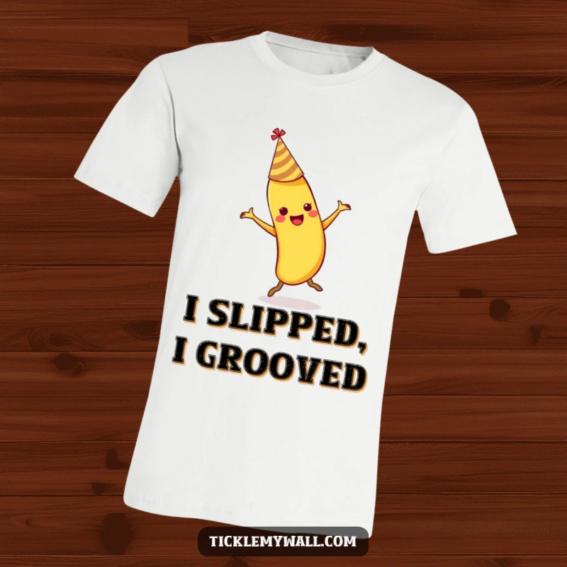 Funny dancing banana wearing a party hat slipping on its own peel on a soft cotton t-shirt.