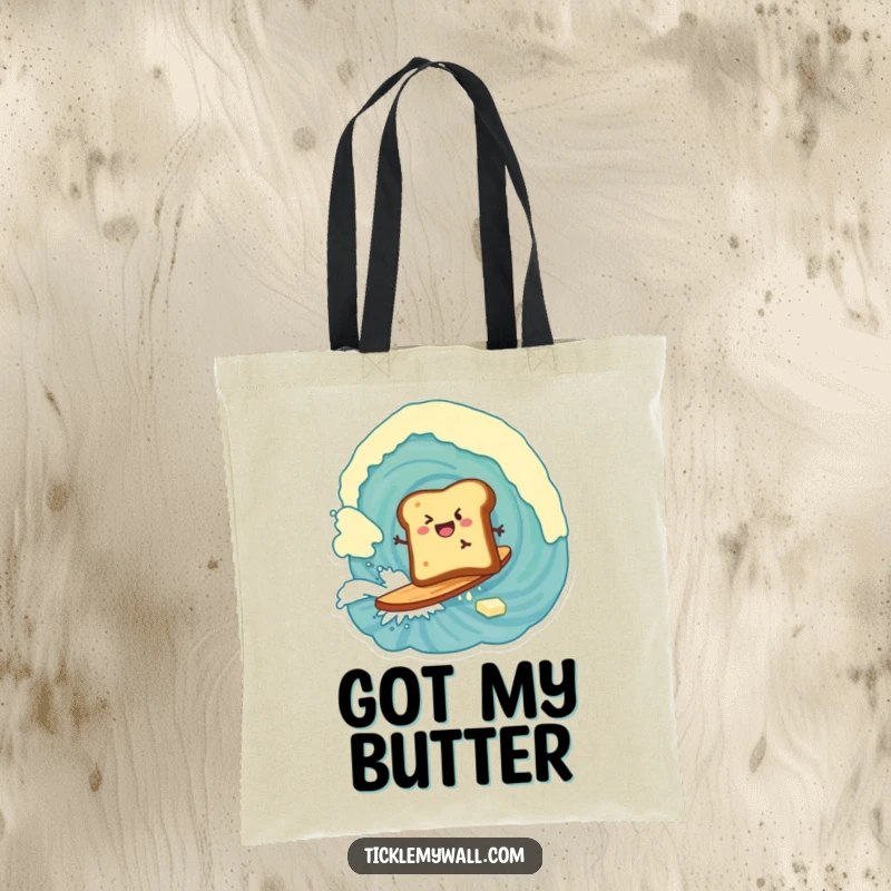 Funny tote bag featuring a piece of toast enthusiastically surfing a colossal wave of butter, a breakfast adventure.